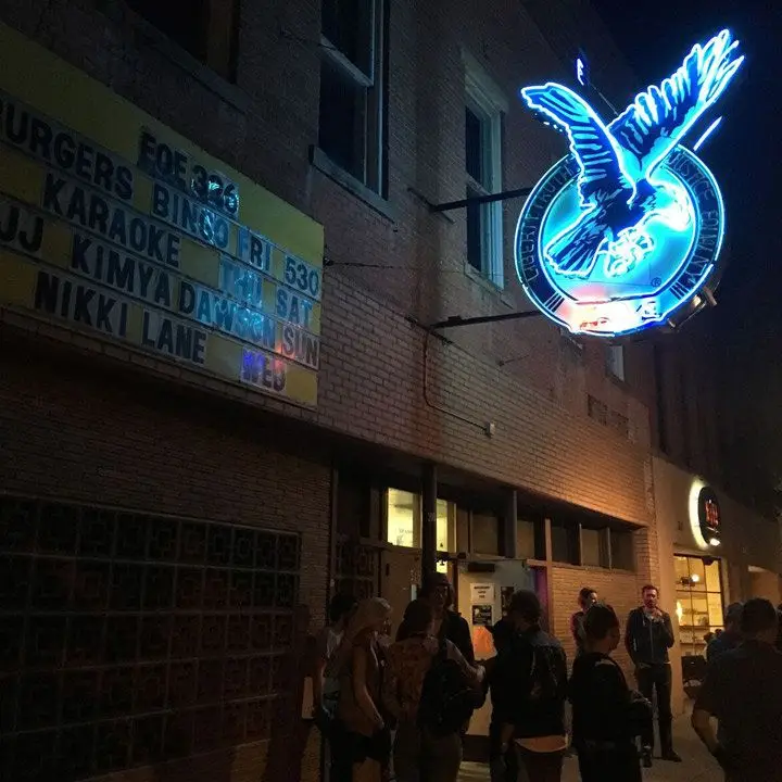 Bozeman Eagles Club & Ballroom with a huge blue neon eagle-emblazoned sign out front