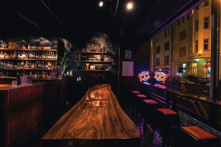 A21 Decades interior with view of rustic wooden table