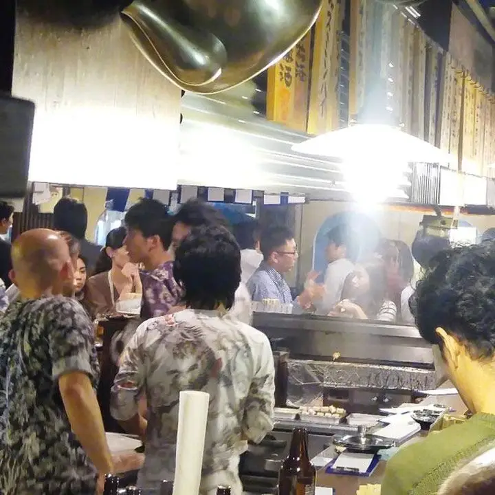 Marugin bar in Tokyo. Packed with guests and brightly lit