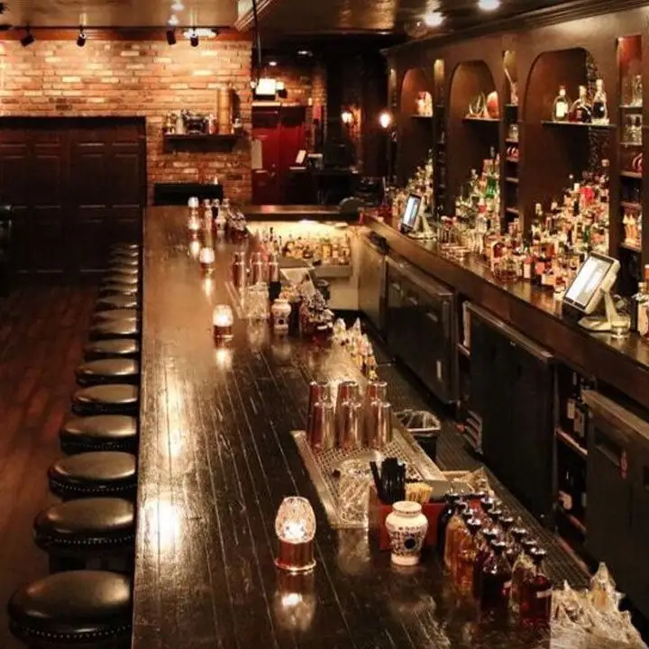 Herbs & Rye bar. Bricks line the back wall and the rounded leather bar stools are inviting
