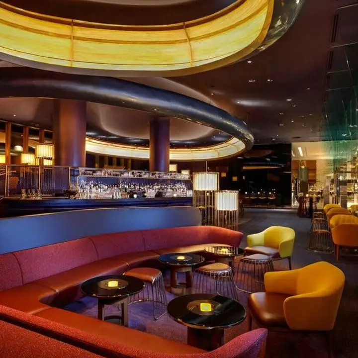 Skyfall Lounge at Delano Las Vegas. Sleek long banquettes and big UFO-like lighting fixtures give a modernized 60s vibe
