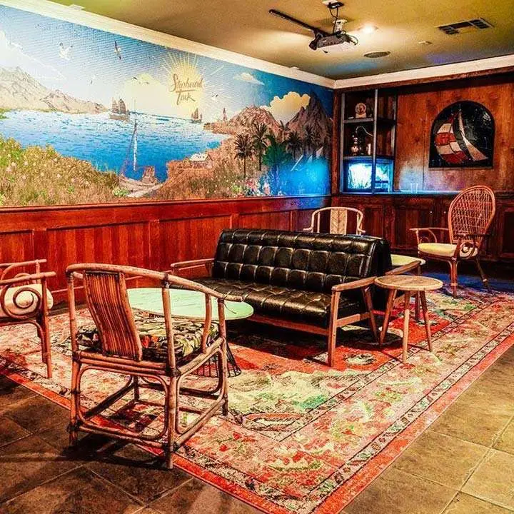 Starboard Tack. A sailboat stained glass window; rattan chairs; and a beachy mural conjure the sailing life