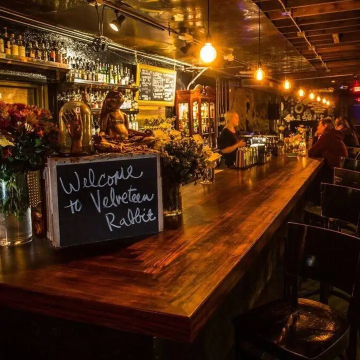 Velveteen Rabbit bar. Dimly lit with edison bubls and a chalkboard with specials