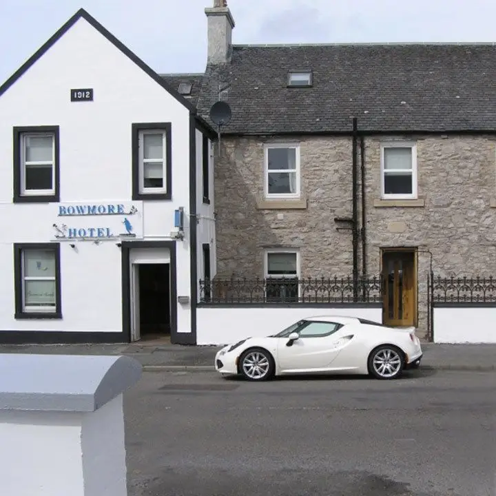 Bowmore Hotel exterior, its main entrance features a roof coming to a V point and a whitewashed exterior