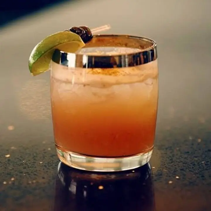 Black Cherry Bittered Sling in a gold-rimmed lowball glass