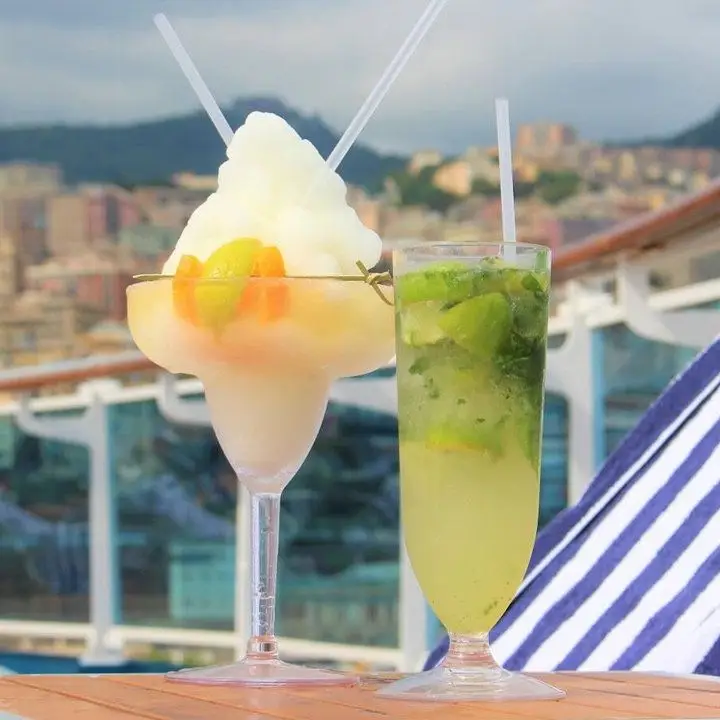 Cocktails on the deck of Princess Cruises. a mojito and a frozen citrus drink in a margarita glass
