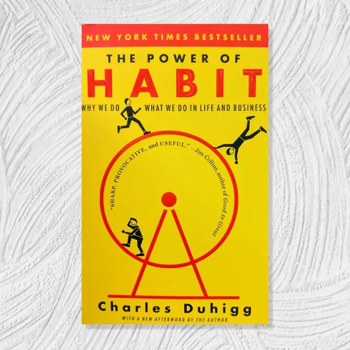 The Power of Habit cover, mustard yellow with red and black text and accents around an illustration of three people on a hamster wheel