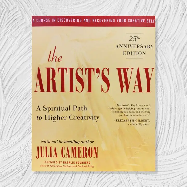 The Artist’s Way cover, soft yellow background with burgundy, black, and white text and accents