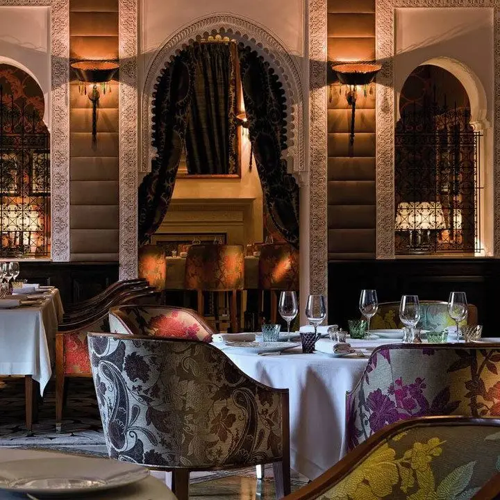 royal mansour hotel dining room, with floral-patterned charis and tall arches