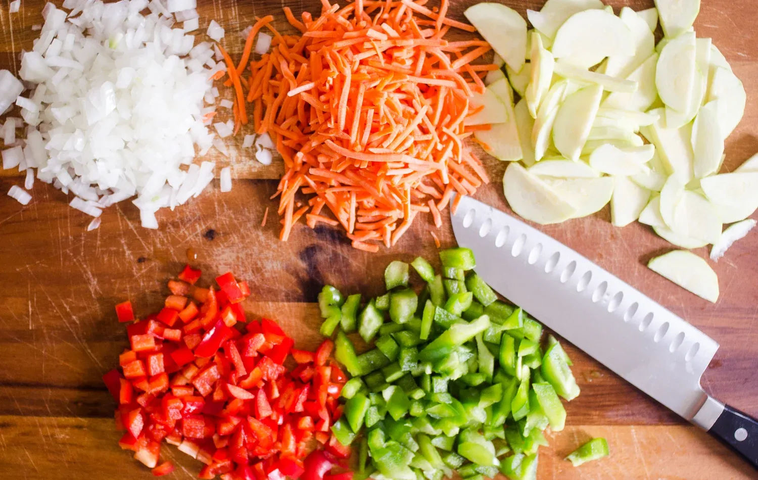 All of the vegetables prepared by chopping on a cutting board. ' title='Easy Stuffed Pepper Casserole