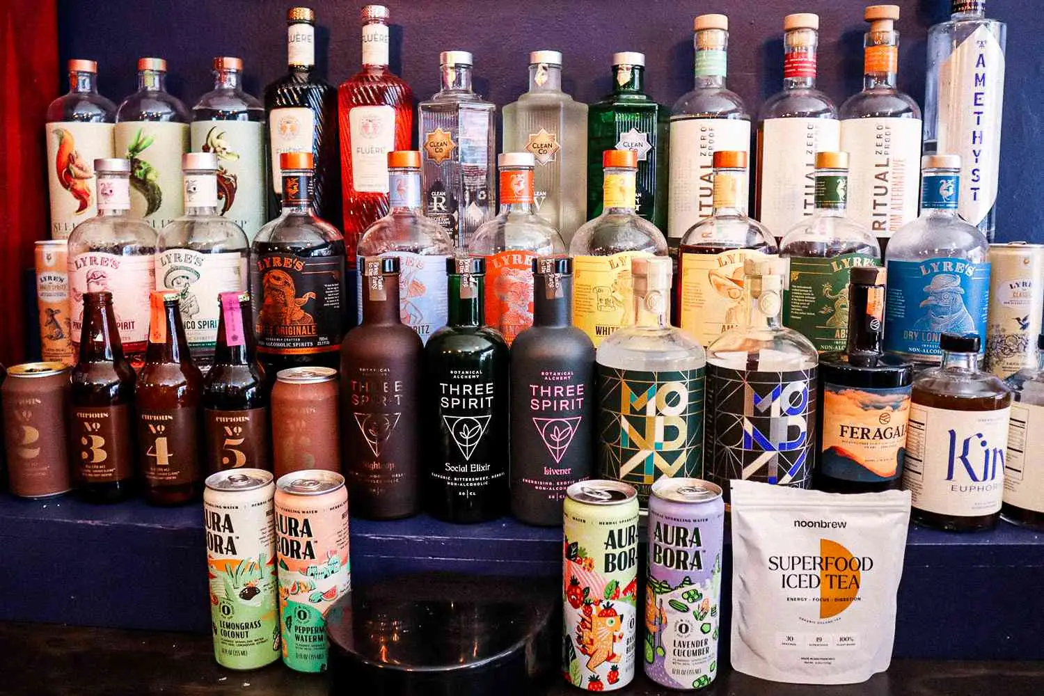 Shelves on the back bar at Hekate showcasing a variety of non-alcoholic spirits and ingredients