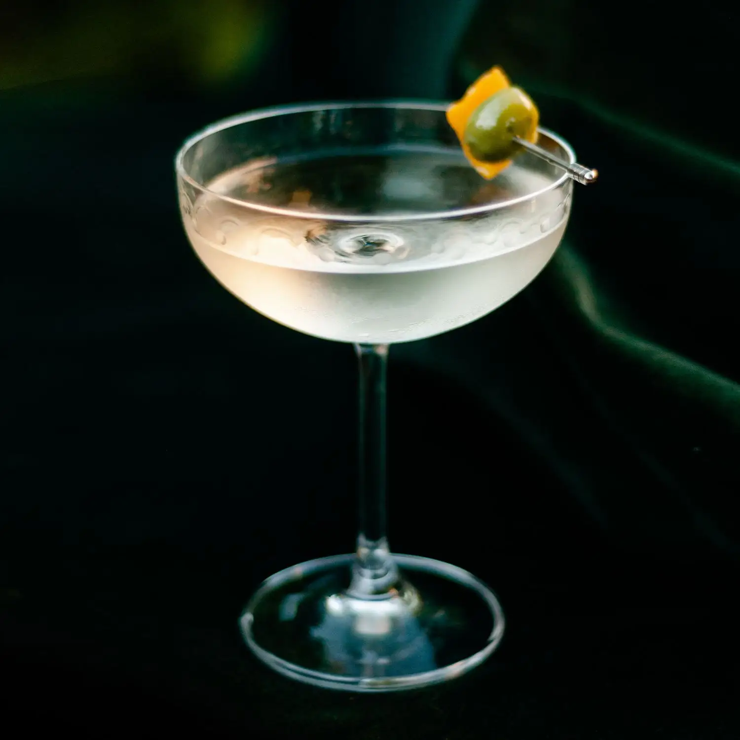 The Host Martini at Church Bar, served in a coupe glass and garnished with a preserved lemon and olive