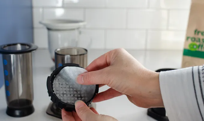 Placing the paper filter in the aeropress.' title='Dirty Chai Latte