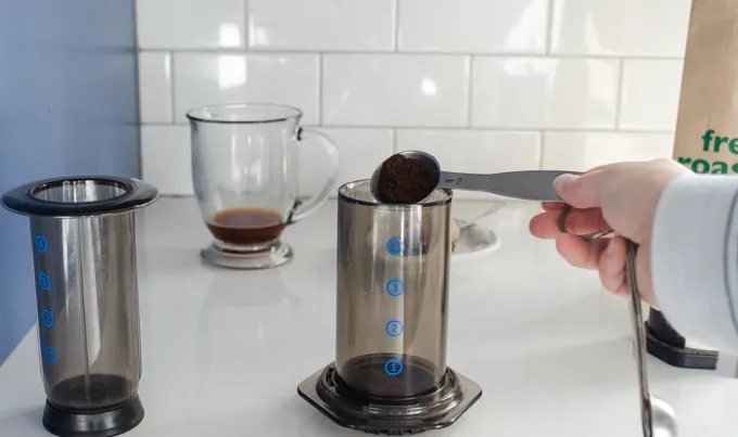 Adding the ground coffee to the aeropress.' title='Dirty Chai Latte