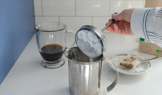 Lifting the lid off of the hand pump milk frother.' title='Dirty Chai Latte