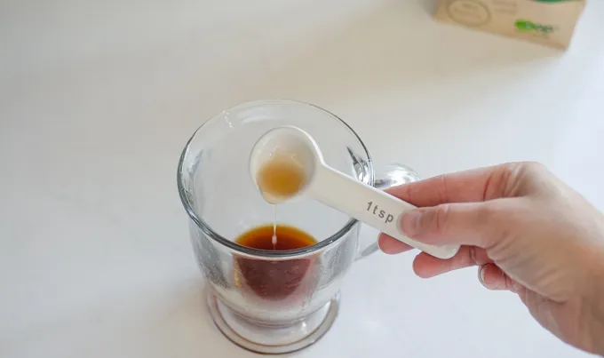 Adding the maple syrup to the mug.' title='Dirty Chai Latte