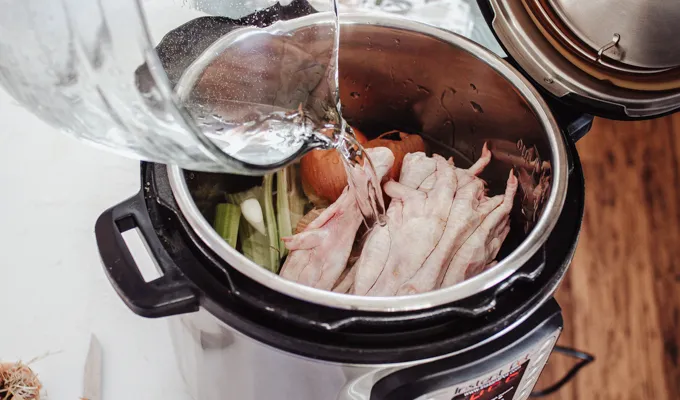 Pouring in the water.' title='Chicken Feet Bone Broth Recipe