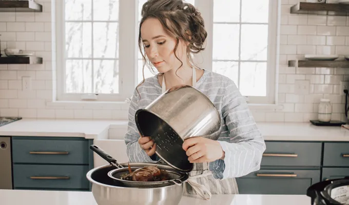 Straining off the Instant Pot chicken feet bone broth.' title='Chicken Feet Bone Broth Recipe