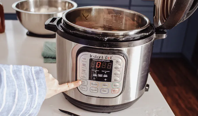Setting the Instant Pot to the Slow Cook function.' title='Chicken Feet Bone Broth Recipe