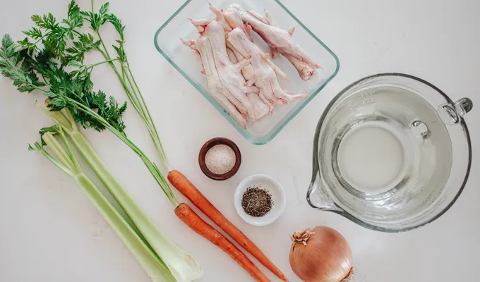 All of the ingredients laid out on a white countertop.' title='Chicken Feet Bone Broth Recipe