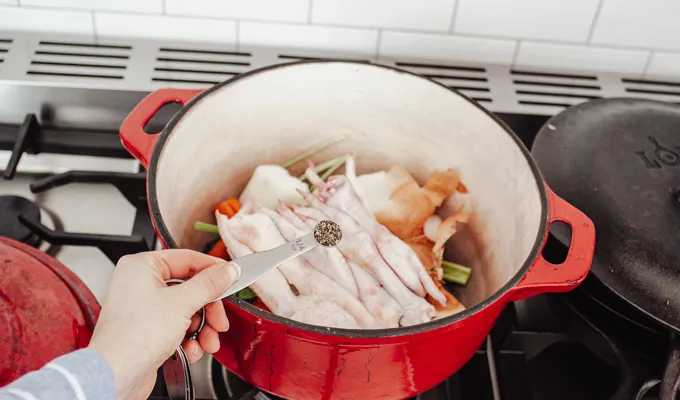 Adding the black pepper.' title='Chicken Feet Bone Broth Recipe