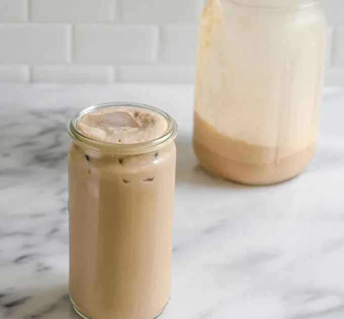 A cup of mocha shakerato with the mason jar in the background.' title='Mocha Frappuccino Recipe