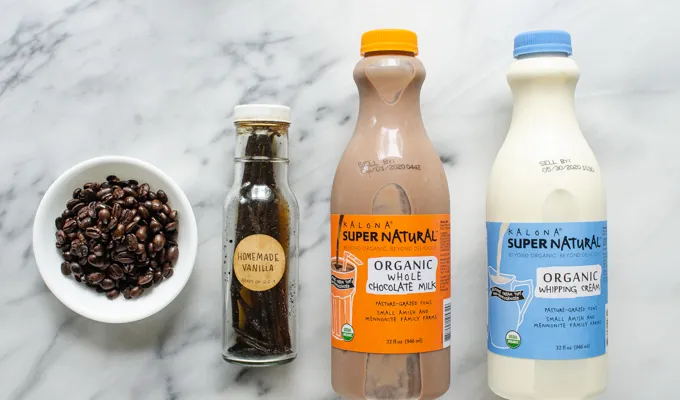 Coffee vanilla extract chocolate milk and heavy cream on a marble surface.' title='Mocha Frappuccino Recipe