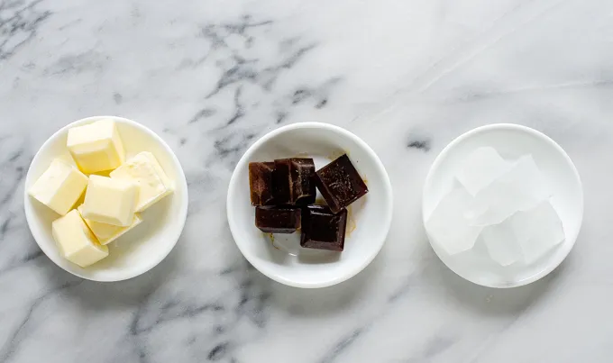 Frozen cream coffee and water in small bowls on a marble surface.' title='Mocha Frappuccino Recipe
