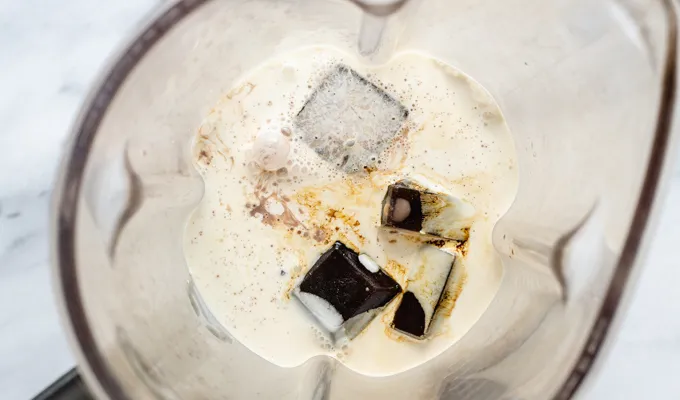 All of the ingredients for a mocha frappuccino in a blender.' title='Mocha Frappuccino Recipe