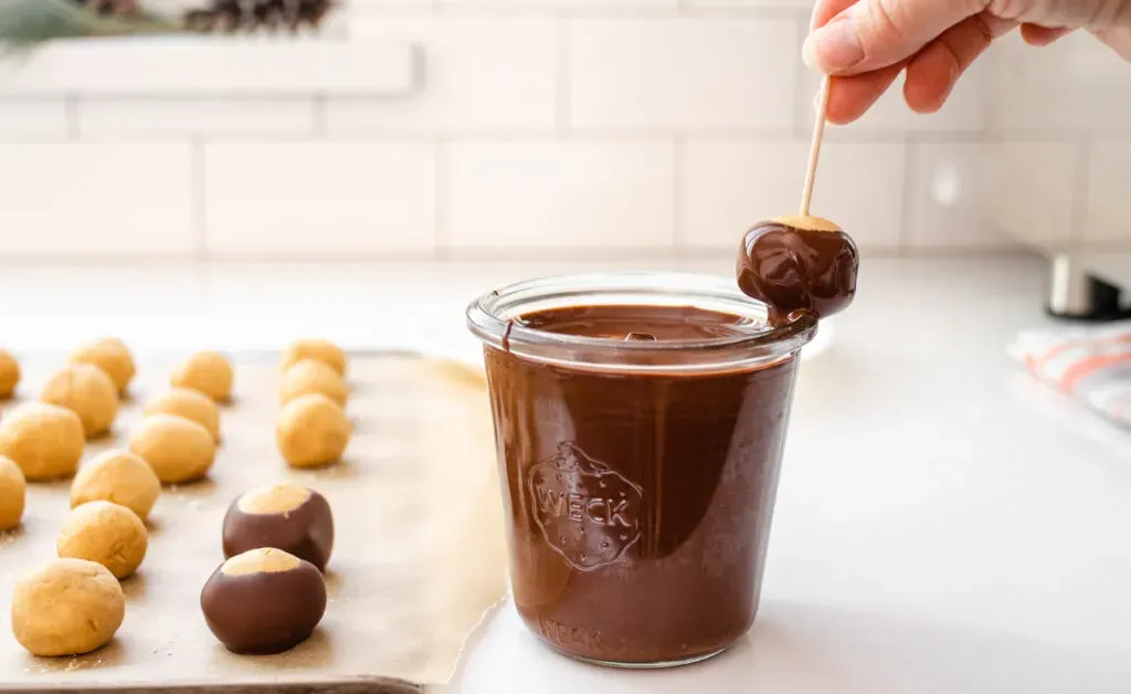 Wiping some of the chocolate off on the side of the glass.' title='Buckeye Recipe Without Shortening