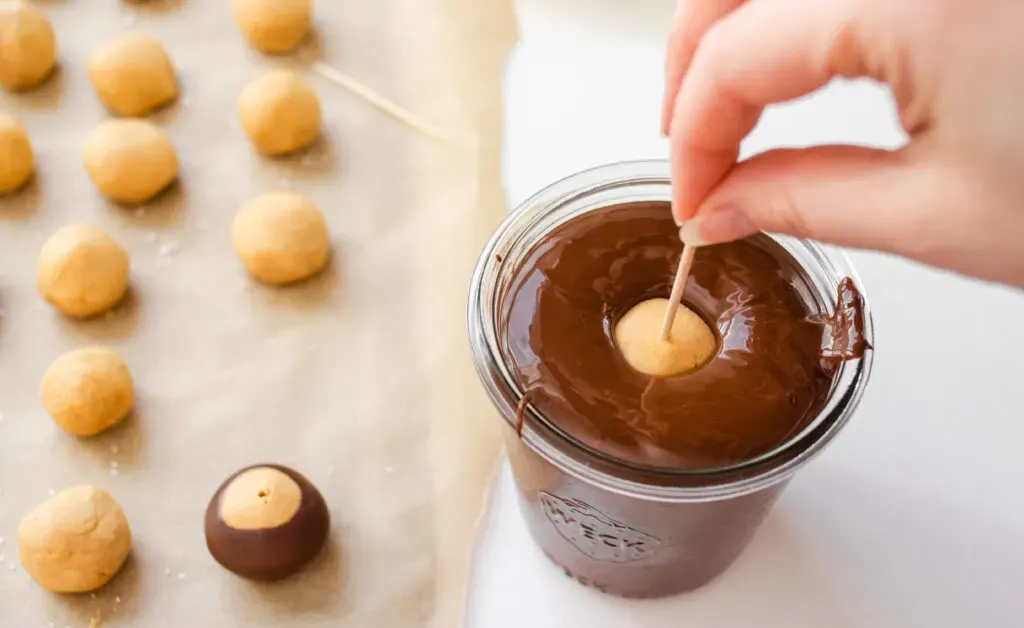 Dipping the peanut butter buckeye into the chocolate without shortening. ' title='Buckeye Recipe Without Shortening