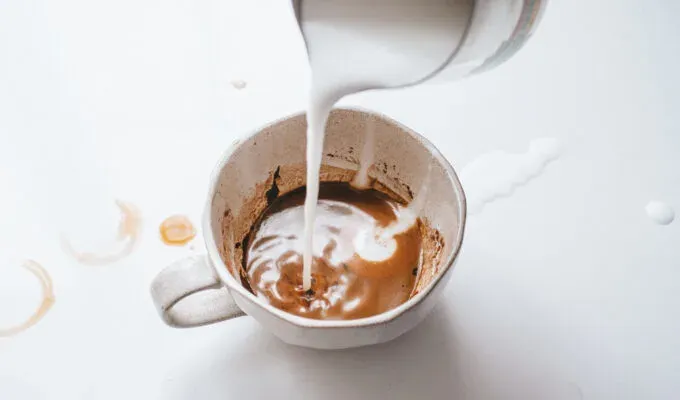 Pouring frothed milk into a cafe mocha.' title='How to Make a Mocha Latte (Easy Homemade Recipe)