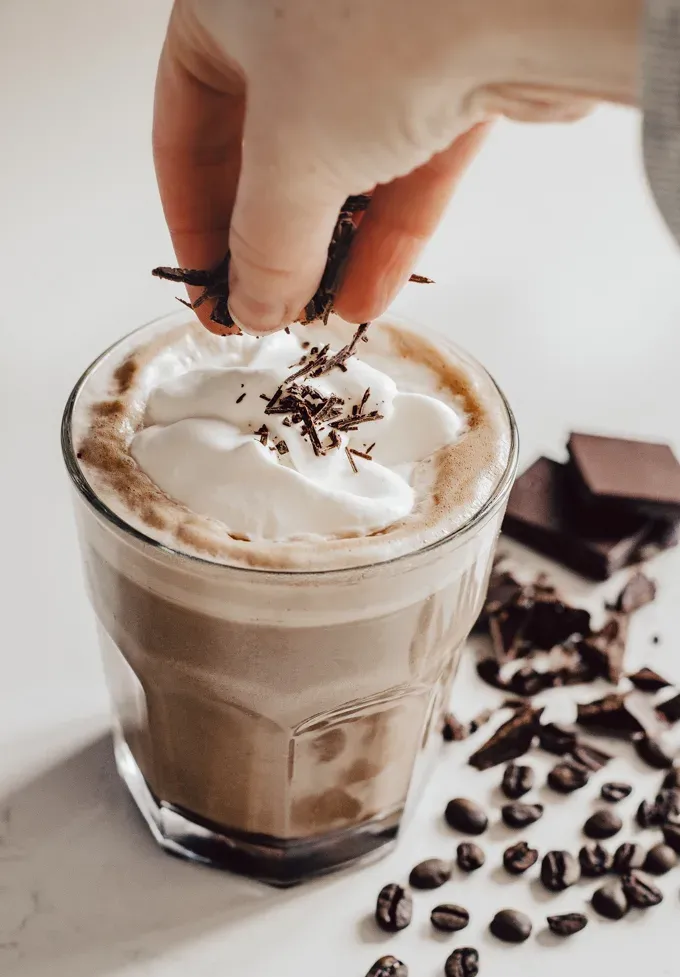 How to Make a Mocha Latte at Home: adding chopped chocolate on top of the whipped cream.' title='How to Make a Mocha Latte (Easy Homemade Recipe)