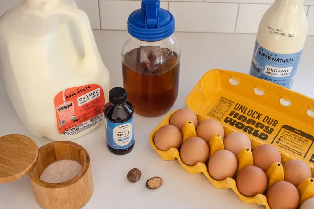 All of the ingredients needed to make cooked eggnog laid out on a counter.' title='Homemade Eggnog