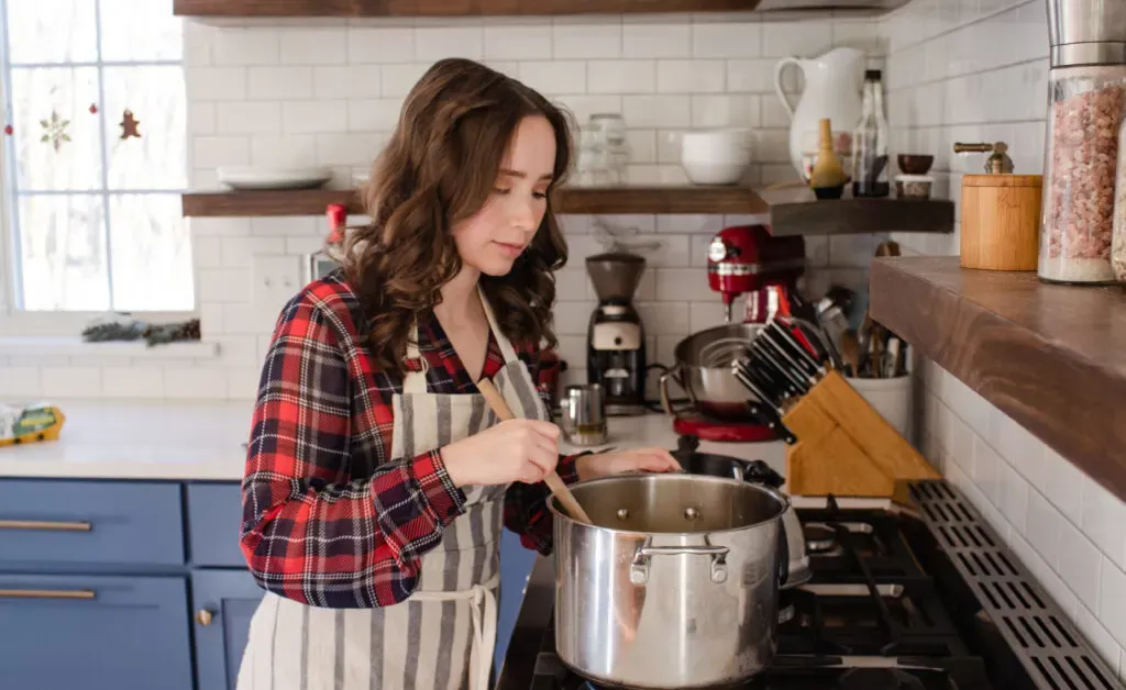 Stirring the eggnog custard over low heat.' title='Homemade Eggnog