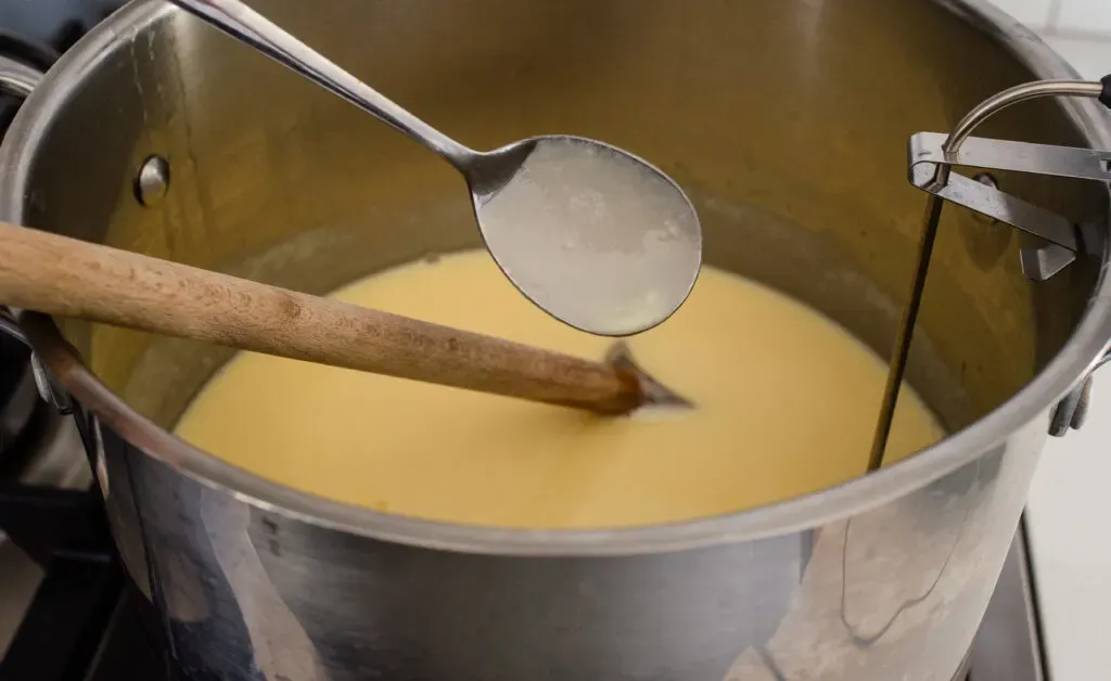 Photo of the eggnog custard coating the back of a spoon.' title='Homemade Eggnog