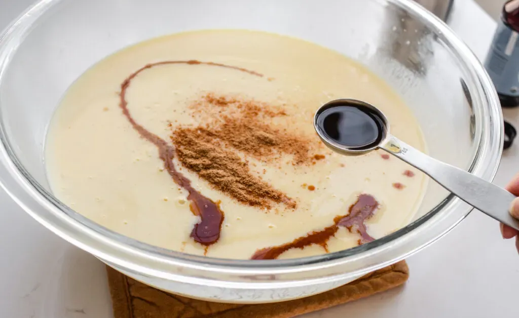 Adding the vanilla extract to the cooked eggnog custard. ' title='Homemade Eggnog