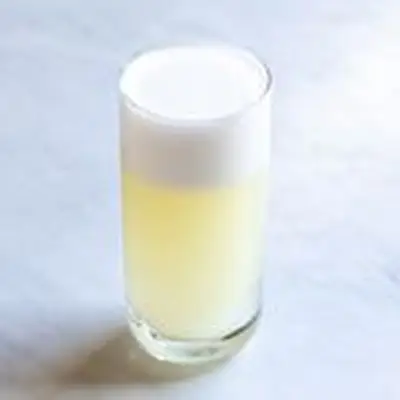 Gin Fizz in a highball glass with thick foam on top