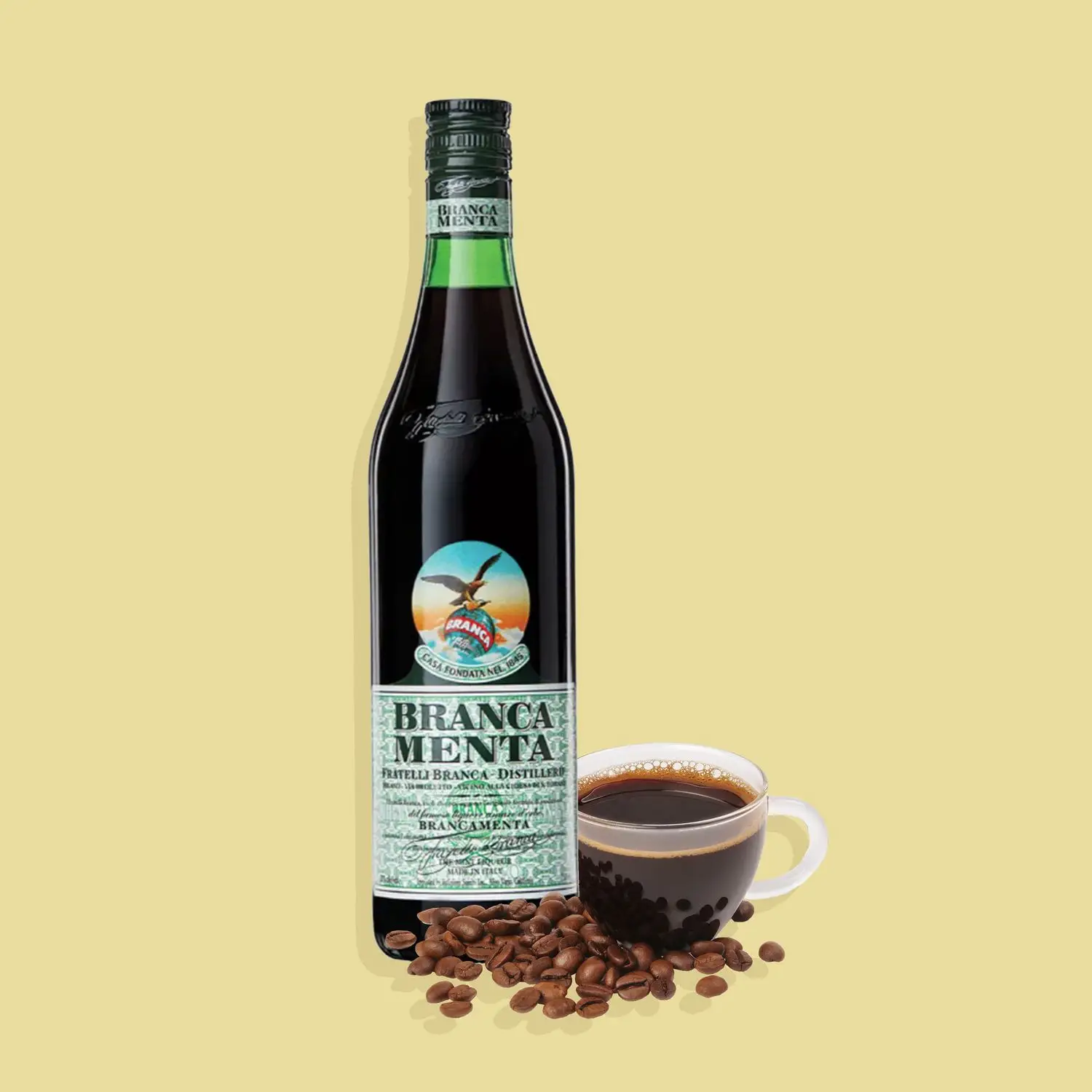 Bottle of Fernet Branca Menta and espresso against yellow background