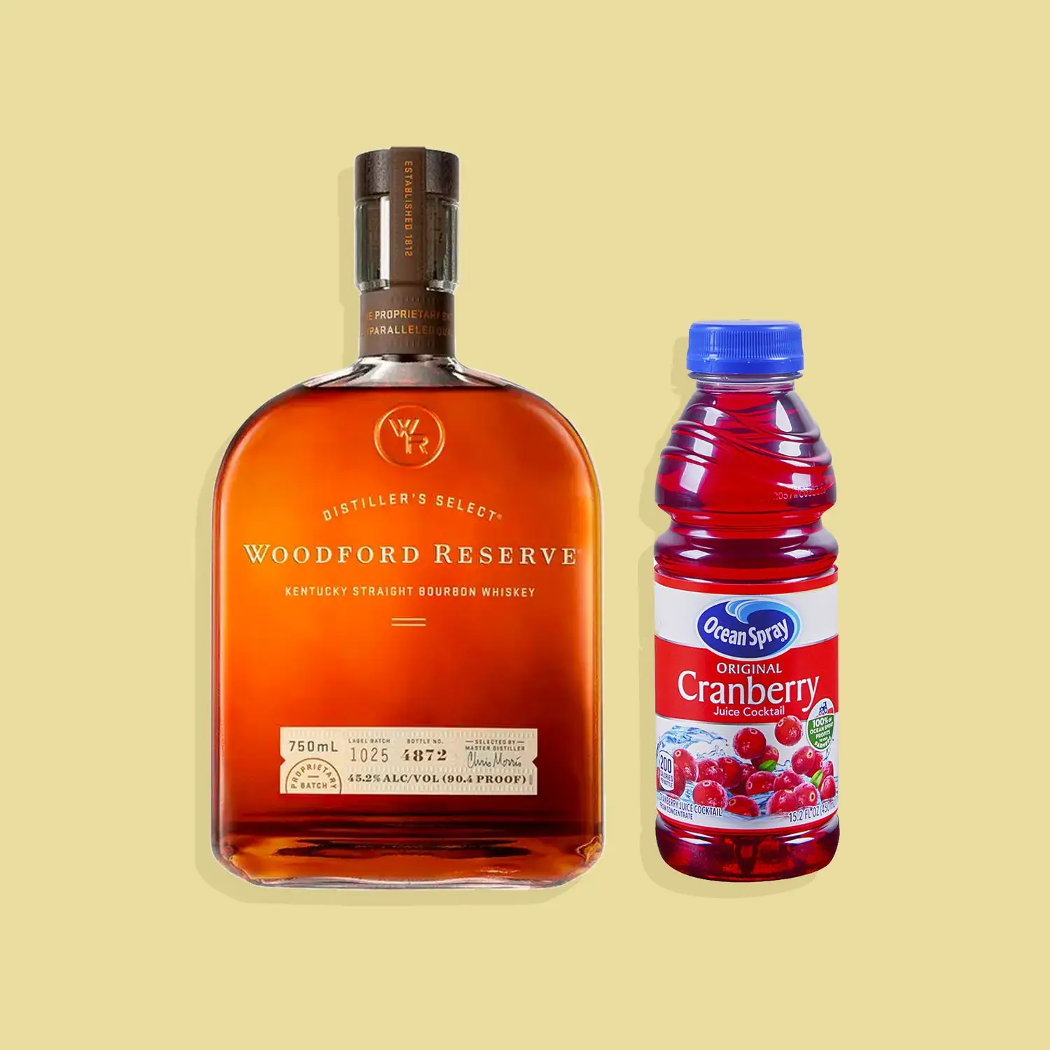 Bottles of Woodford Reserve bourbon and Ocean Spray cranberry juice against yellow background
