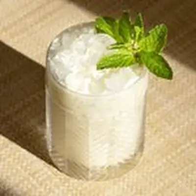 Pina Verde cocktail with mint sprig garnish