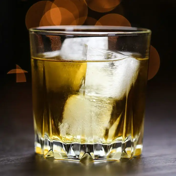 whiskey mac cocktail on the rocks, served on a wooden bar