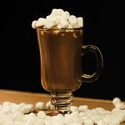 boozy hot chocolate cocktail in a glass mug with mini marshmallows
