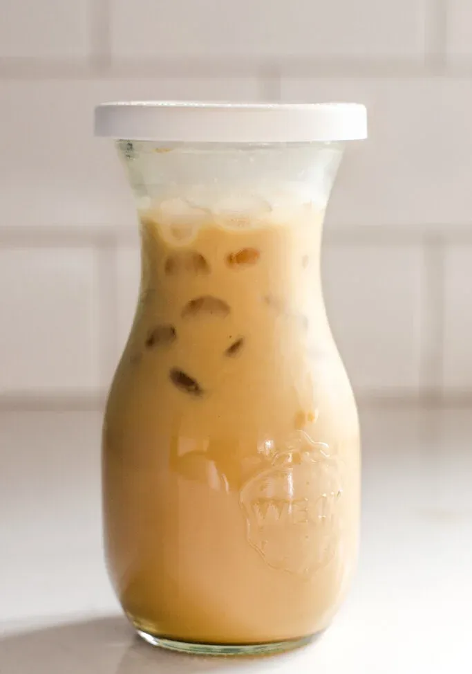 A jar of homemade Starbucks bottled Frappuccino on a white counter with white subway tile backsplash in the background. ' title='Starbucks Bottled Frappuccino Recipe