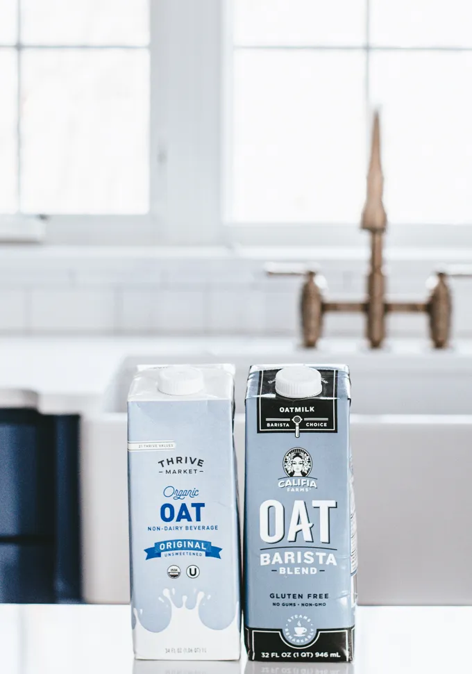 Two different kinds of oat milks that you can use to make an oat milk latte.' title='Oat Milk Latte