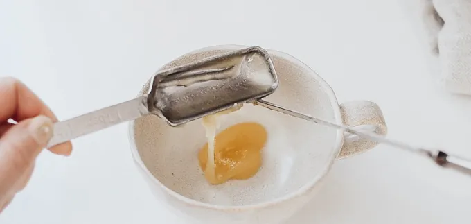 Adding honey to a mug.' title='Oat Milk Latte