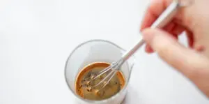 Whisking instant coffee with hot water to make a shot of espresso.' title='How to Make an Espresso Shot with Instant Coffee