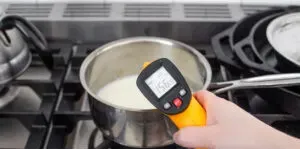 Heating milk over the stove to froth for a latte.' title='How to Make an Espresso Shot with Instant Coffee