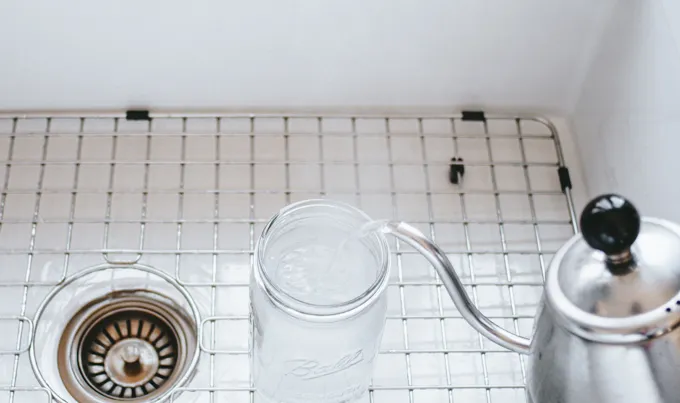 Sterilizing a wide mouth glass jar for making sauerkraut.' title='Easy Spicy Sauerkraut Recipe