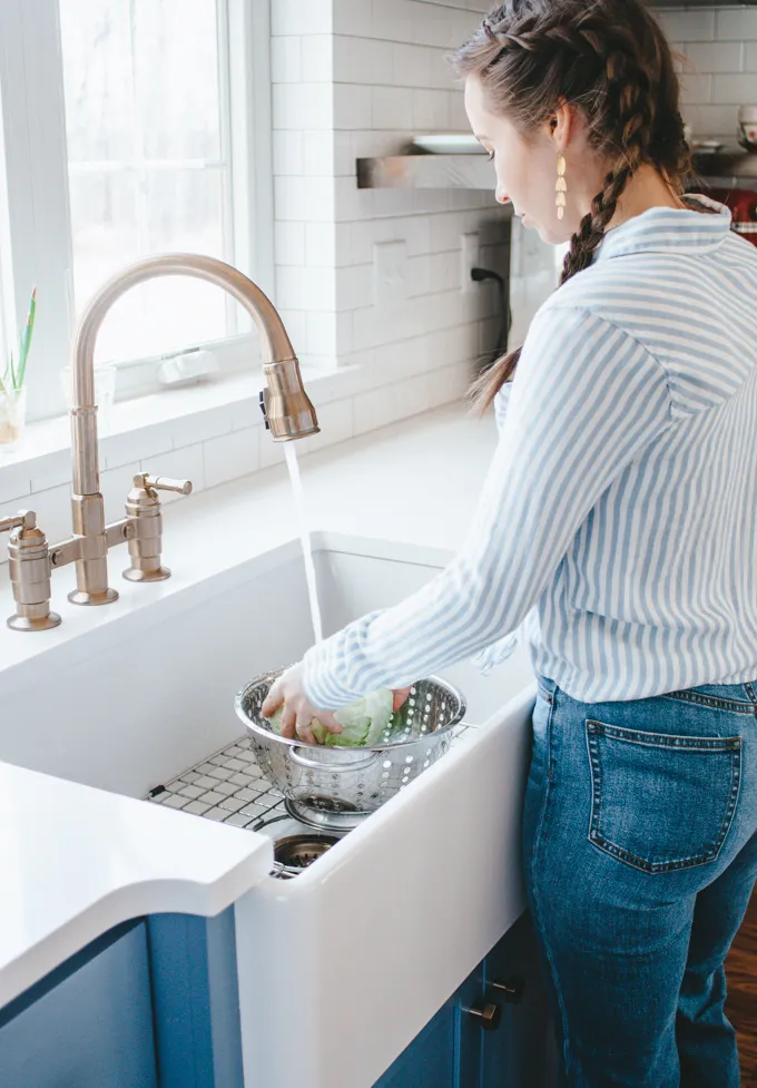 Washing a head of cabbage in preparation for making spicy sauerkraut' title='Easy Spicy Sauerkraut Recipe